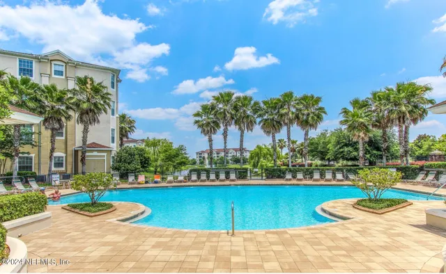 a front view of a house with swimming pool and patio