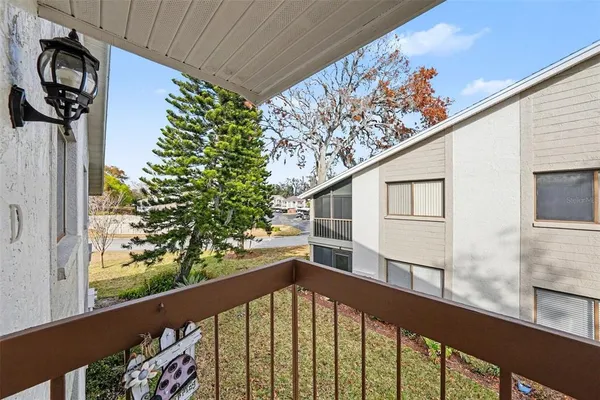 a view of a balcony with wooden floor