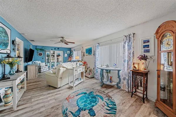 a living room with furniture fireplace and wooden floor