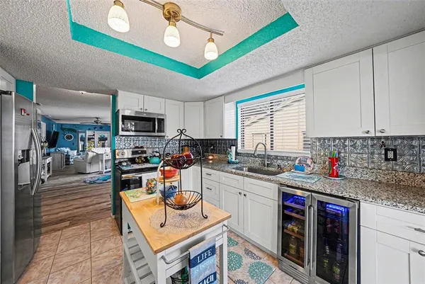 a kitchen with stainless steel appliances granite countertop a sink dishwasher stove and cabinets
