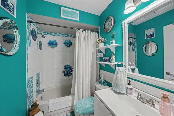 a bathroom with a sink a toilet and a shower