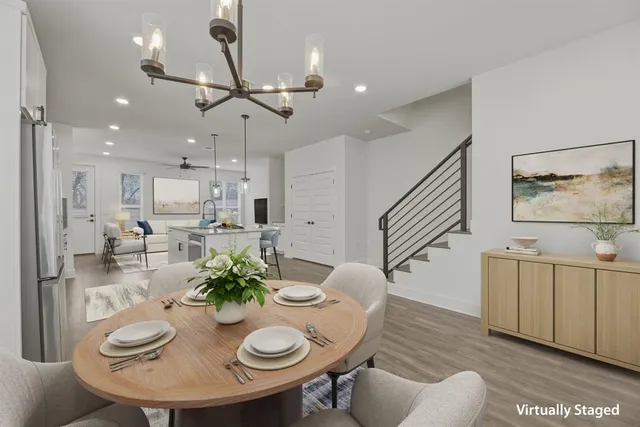 a dining room with furniture a chandelier and wooden floor