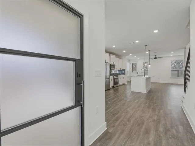 a living room with furniture and kitchen view