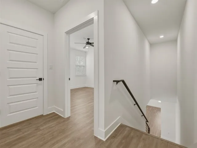 a kitchen with stainless steel appliances kitchen island granite countertop a stove a sink cabinets and wooden floor