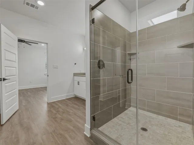 a view of walk in closet with wooden floor and closet