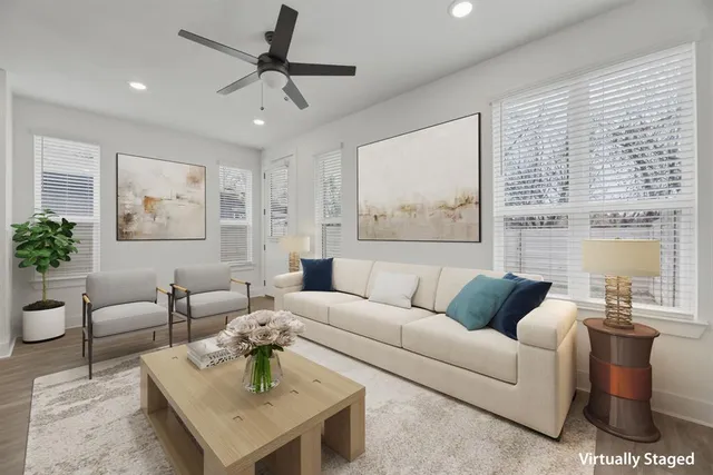 a kitchen with a dining table chairs wooden floor cabinets and stainless steel appliances