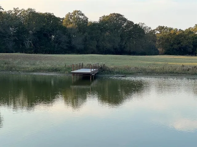 a view of a lake with houses in the back