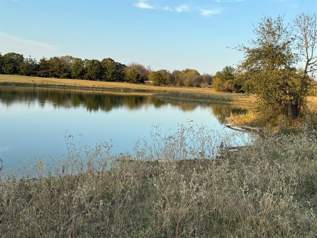 3827 County Road 3827 Wills Point, TX 75169 - Photo 18 of 25 a view of a lake with houses in the back