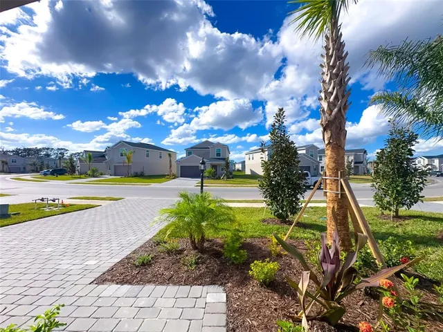 a view of yard with swimming pool and green space