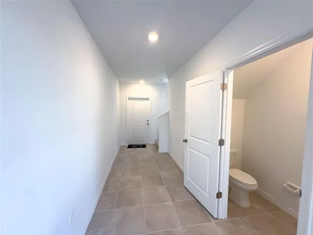 a bathroom with a granite countertop sink a toilet and a shower