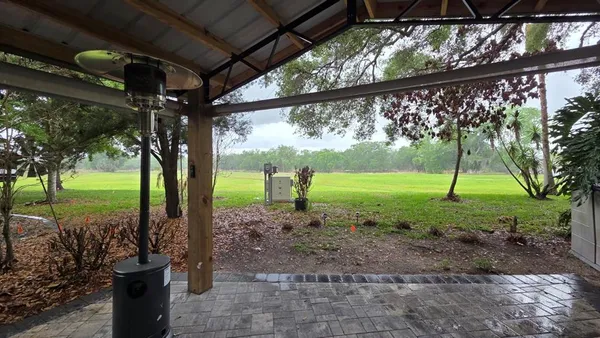 a view of a room with a big yard