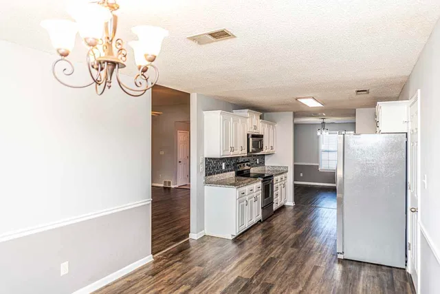 a kitchen with stainless steel appliances a refrigerator and a stove