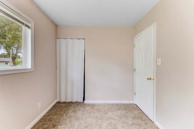 a view of an empty room with windows