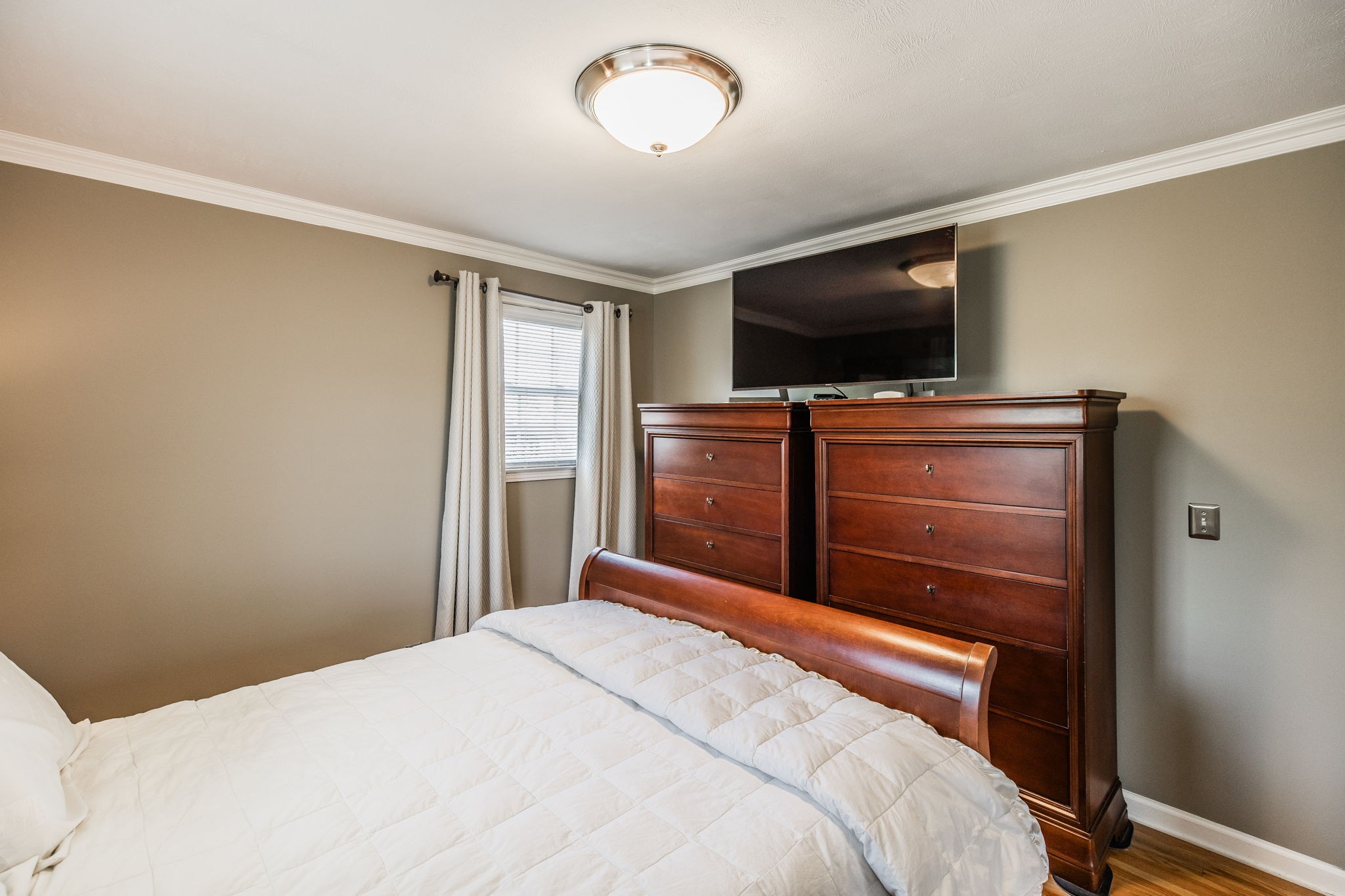 926 Hart Street Gallatin, TN 37066 - Photo 19 of 53 a bedroom with a bed and a flat screen tv