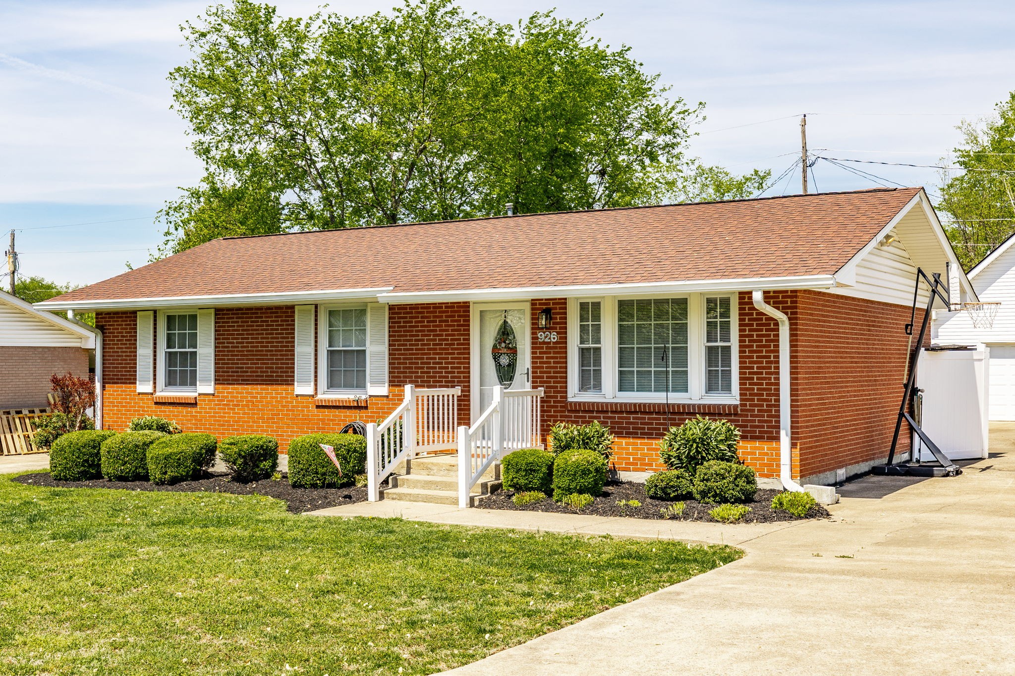 926 Hart Street Gallatin, TN 37066 - Photo 4 of 53 a front view of a house with a yard and potted plants