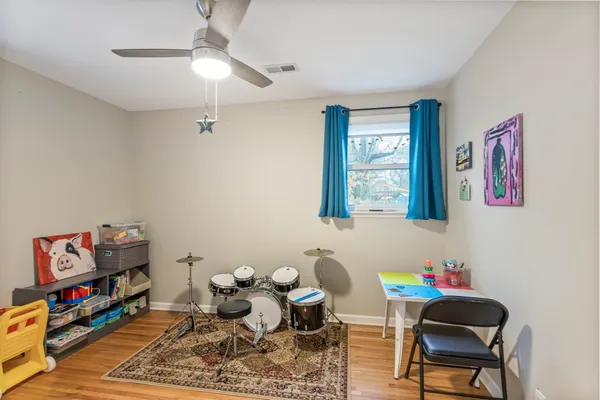 a living room with furniture and a bookshelf