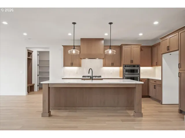 a kitchen with kitchen island white cabinets and stainless steel appliances