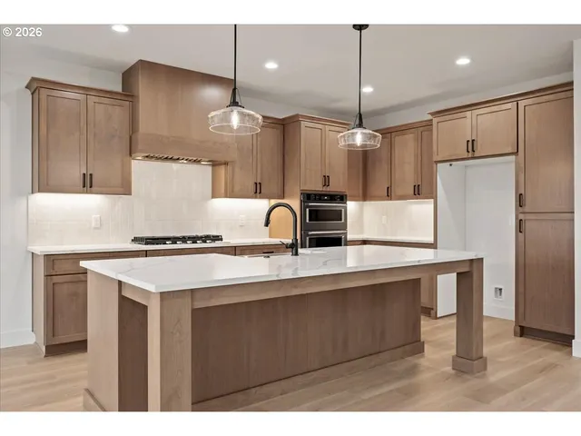 a kitchen with a sink stove and refrigerator