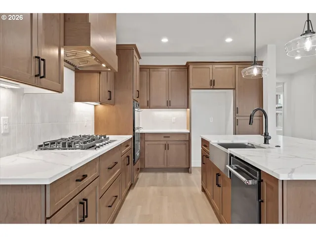 a kitchen with a sink a counter and appliances