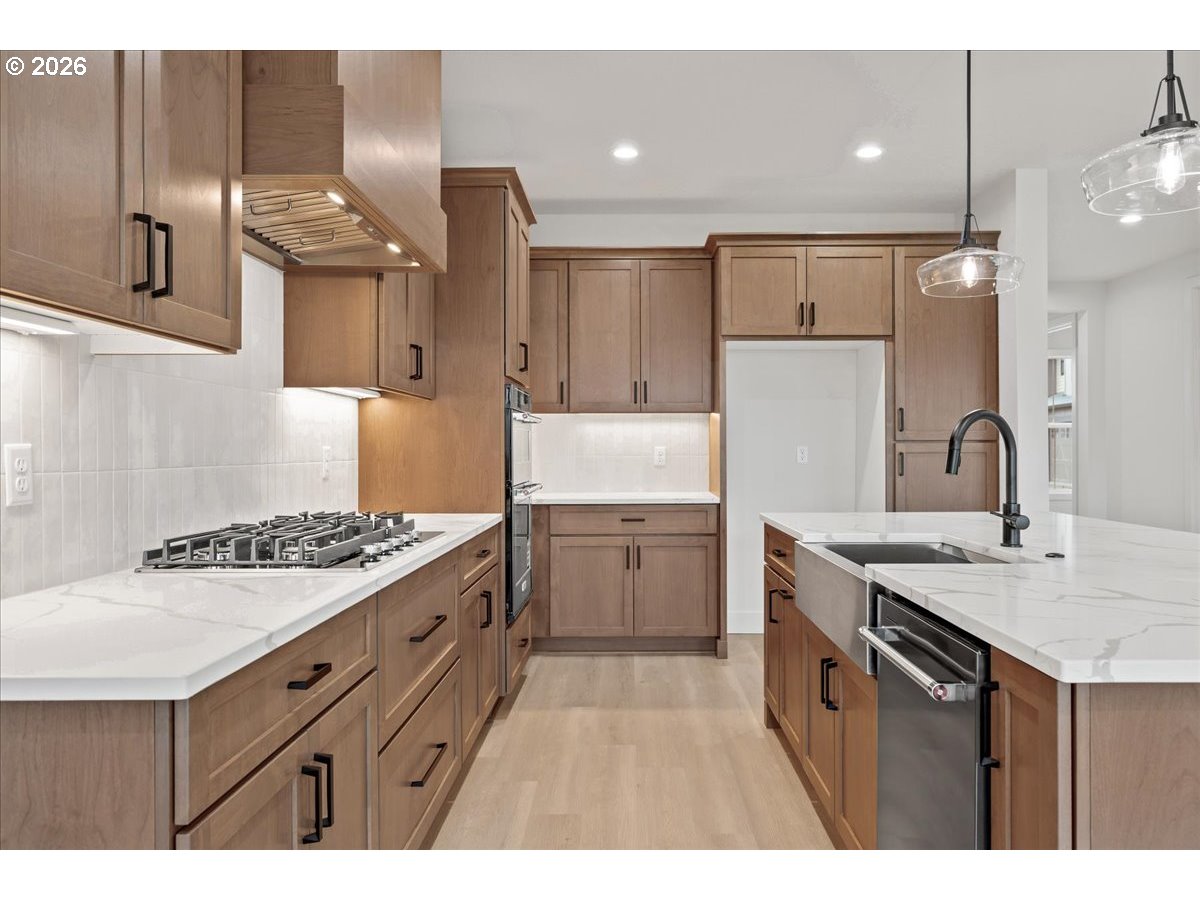 3509 North 11th Circle Ridgefield, WA 98642 - Photo 14 of 43 a kitchen with a sink stove and refrigerator
