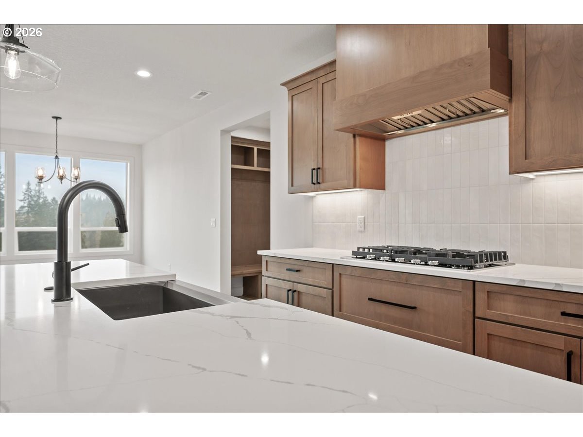 3509 North 11th Circle Ridgefield, WA 98642 - Photo 16 of 43 a kitchen with granite countertop a stove and a sink