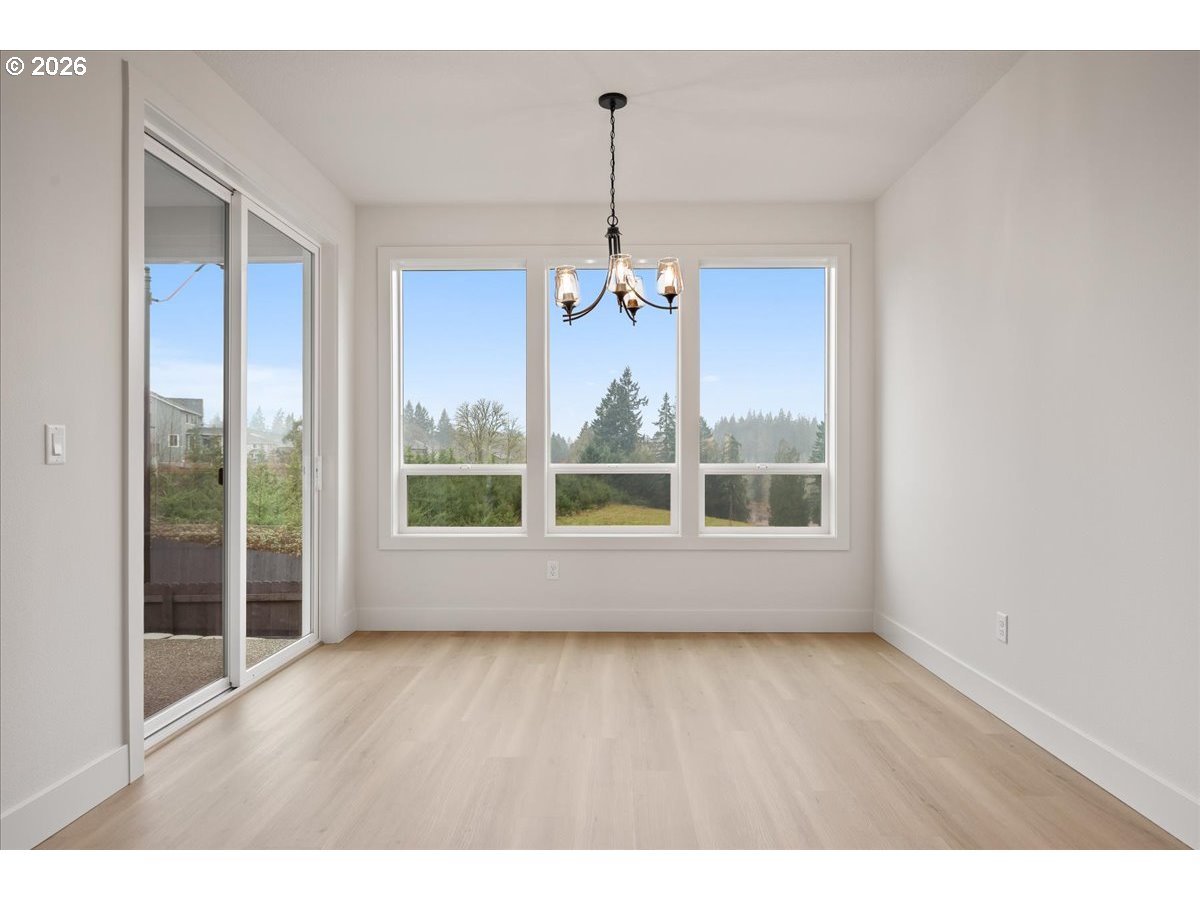 3509 North 11th Circle Ridgefield, WA 98642 - Photo 20 of 43 a view of an empty room with wooden floor and a window