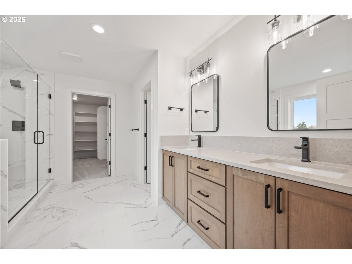 3509 North 11th Circle Ridgefield, WA 98642 - Photo 29 of 43 a spacious bathroom with a granite countertop sink mirror and a