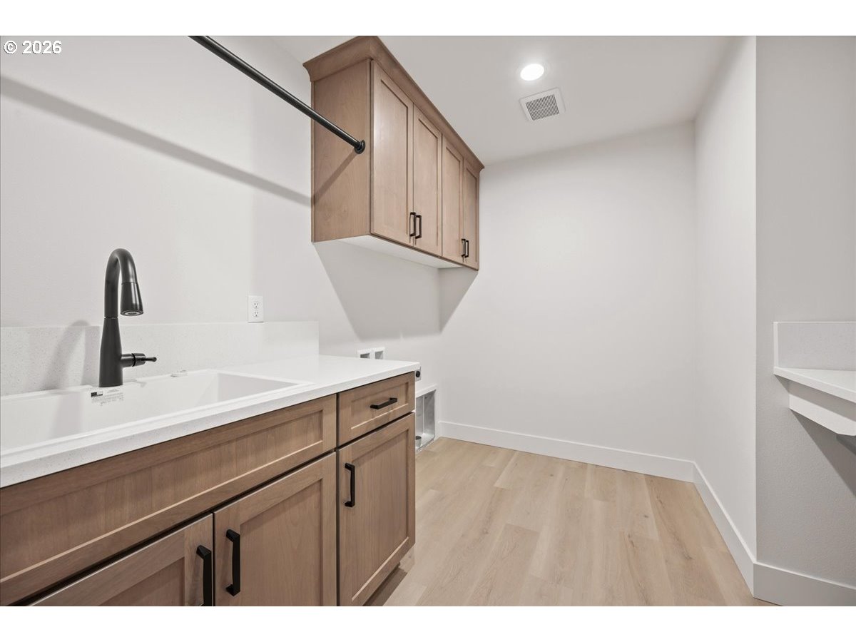 3509 North 11th Circle Ridgefield, WA 98642 - Photo 36 of 43 a kitchen with a sink and cabinets
