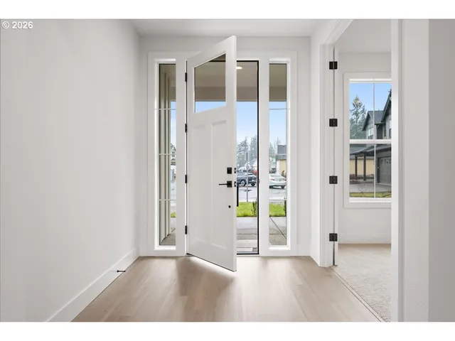 a view of an empty room and wooden floor