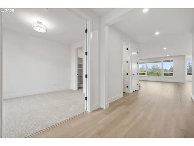 a view of empty room with wooden floor and fireplace