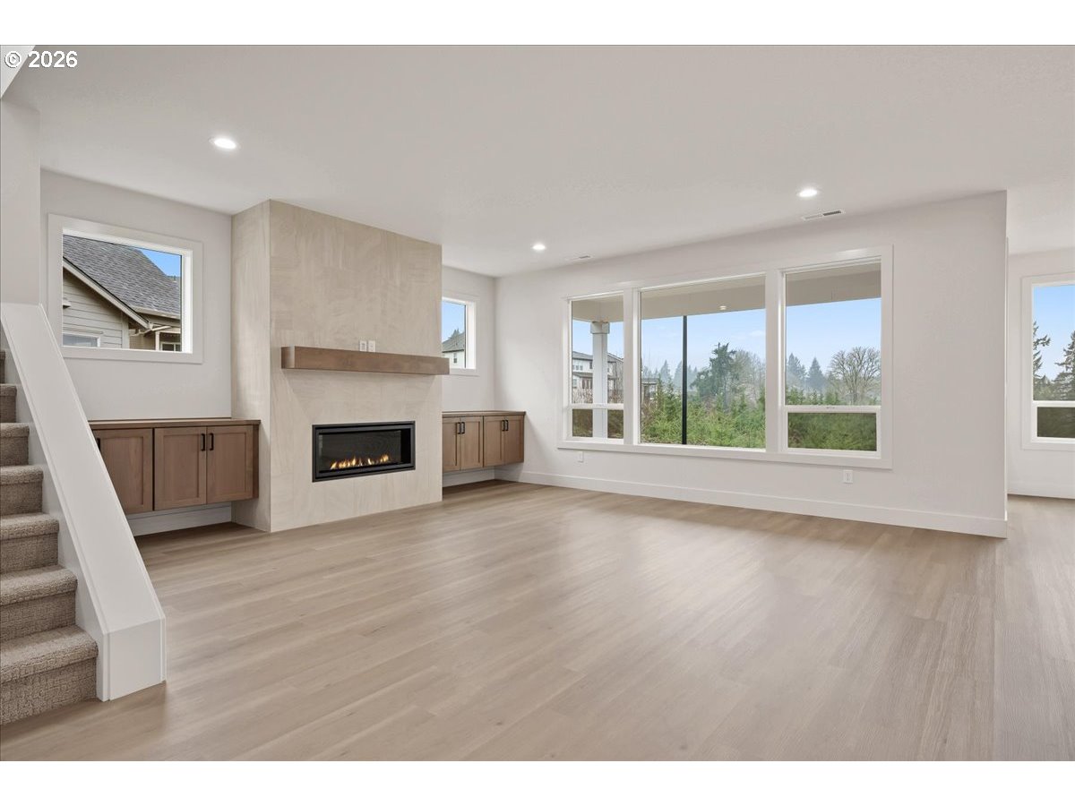 3509 North 11th Circle Ridgefield, WA 98642 - Photo 6 of 43 a view of empty room with wooden floor and fireplace