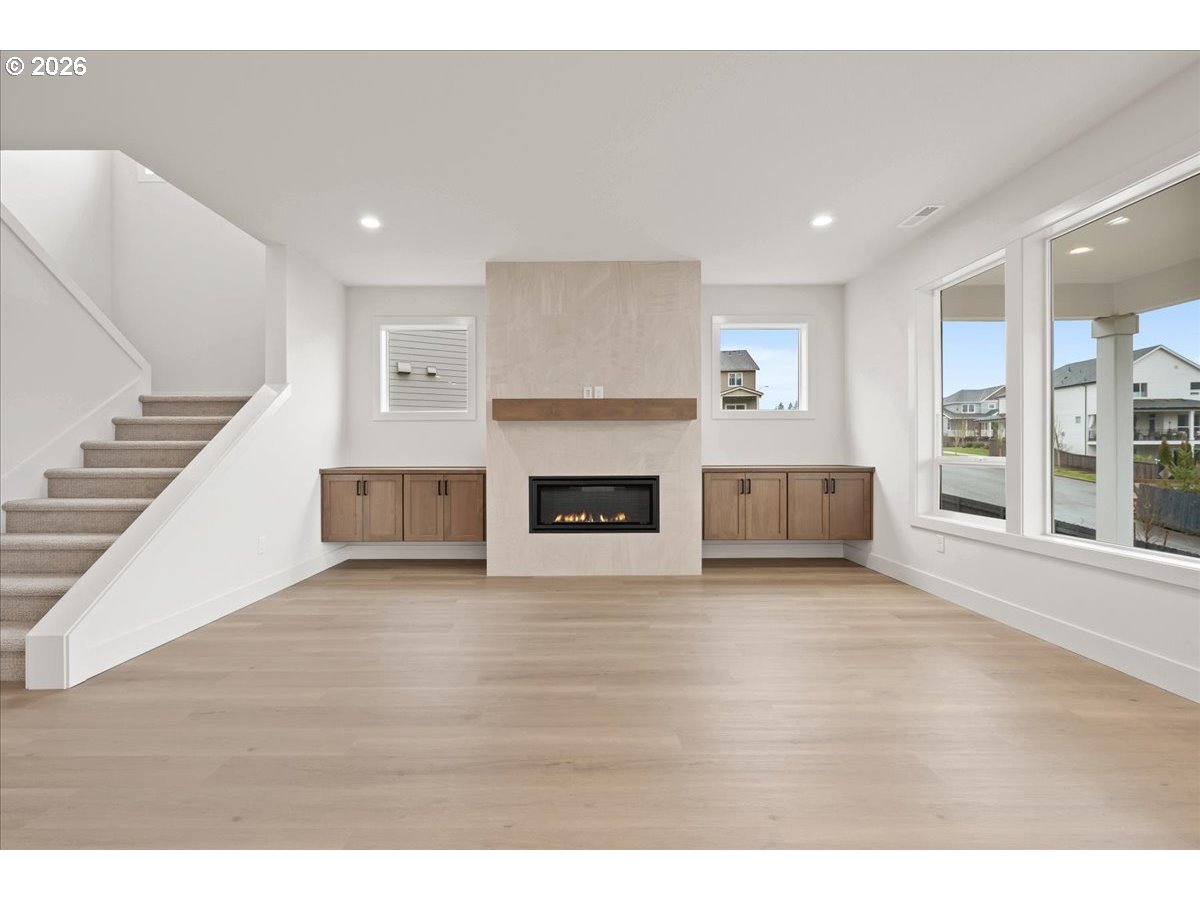 3509 North 11th Circle Ridgefield, WA 98642 - Photo 7 of 43 a view of empty room with wooden floor and fireplace
