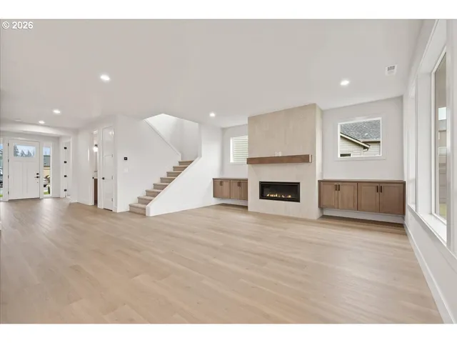 a view of kitchen with kitchen island stainless steel appliances refrigerator oven with large window