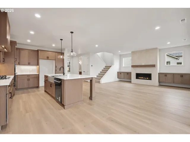 a large kitchen with kitchen island a sink stainless steel appliances and cabinets