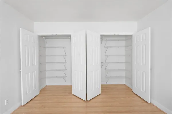 a view of a room with wooden floor