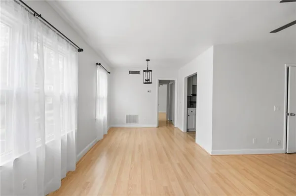 a view of a hallway with wooden floor and staircase