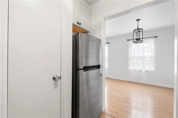 a view of a refrigerator in kitchen and wooden floor