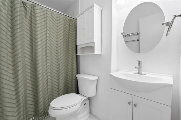 a bathroom with a toilet a sink and a mirror