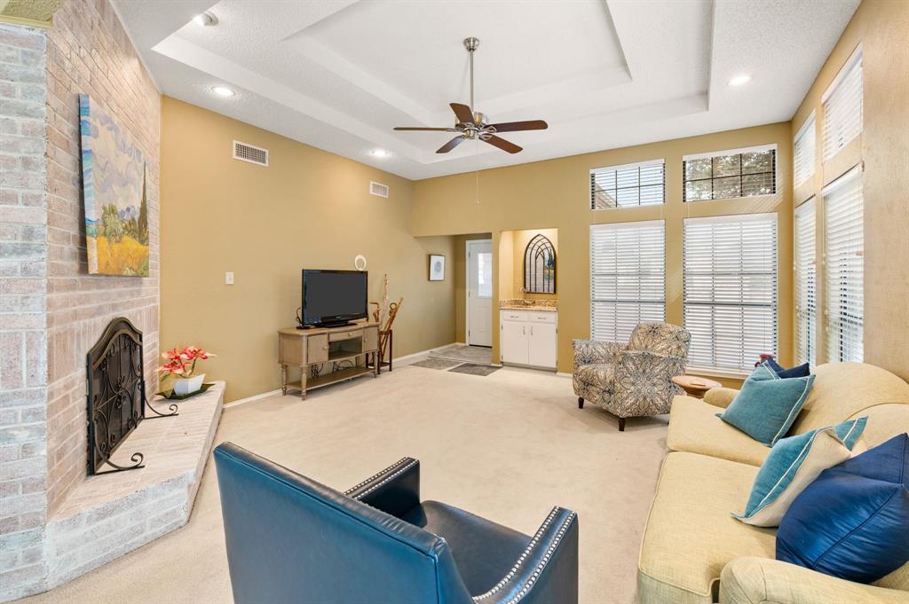 1828 Realistic Court Bedford, TX 76021 - Photo 3 of 16 a living room with furniture a fireplace and a flat screen tv
