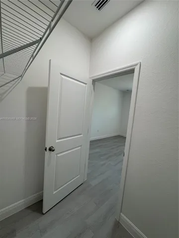 an empty room with closet and windows