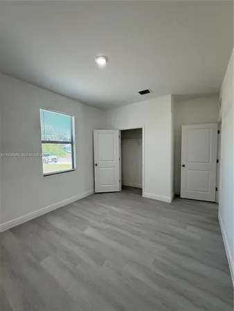 a bathroom with double vanity and a mirror