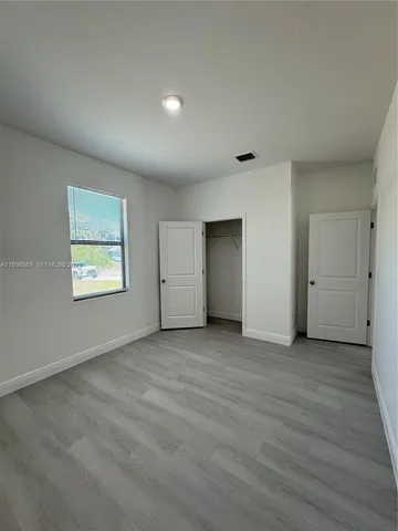 a bathroom with double vanity and a mirror