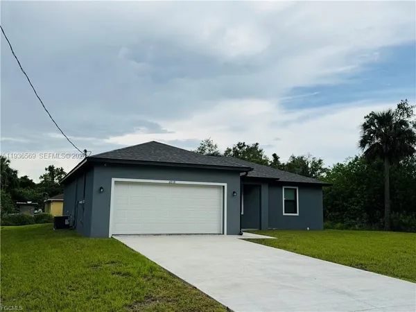 a front view of a house with a garden