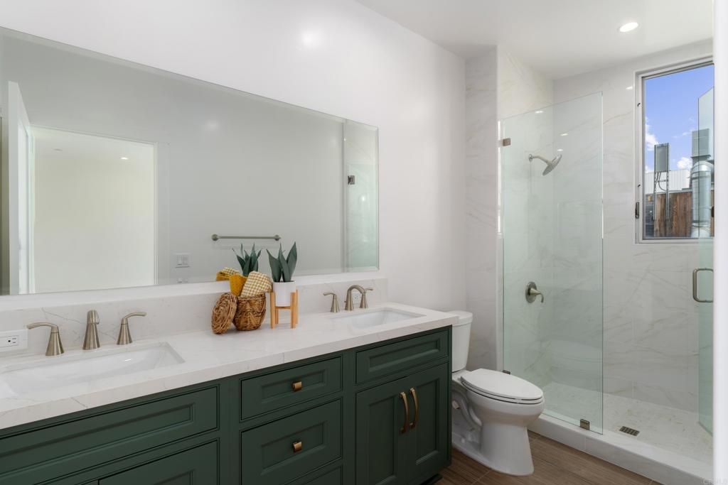 2648 State Street, Unit E Carlsbad, CA 92008 - Photo 11 of 24 a bathroom with a sink a toilet and shower