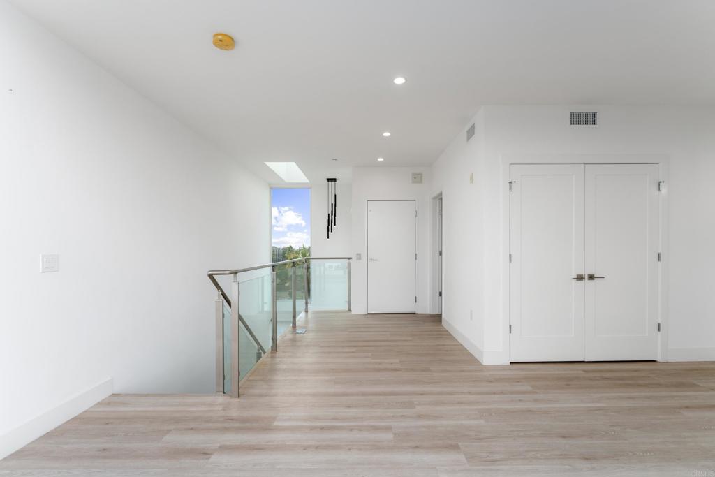 2648 State Street, Unit E Carlsbad, CA 92008 - Photo 13 of 24 a view of empty room with wooden floor