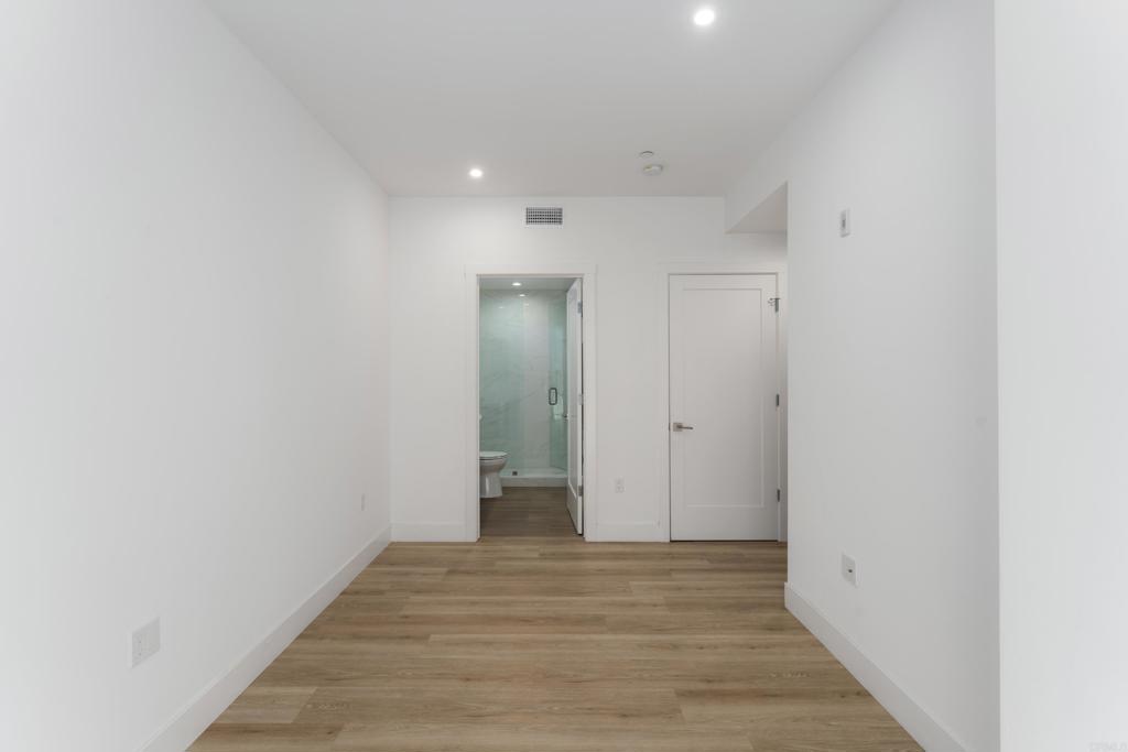 2648 State Street, Unit E Carlsbad, CA 92008 - Photo 8 of 24 a view of a hallway with wooden floor