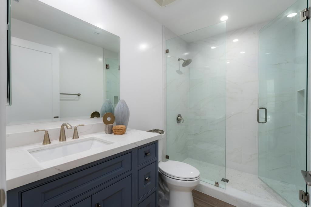 2648 State Street, Unit E Carlsbad, CA 92008 - Photo 9 of 24 a bathroom with a sink a toilet and shower