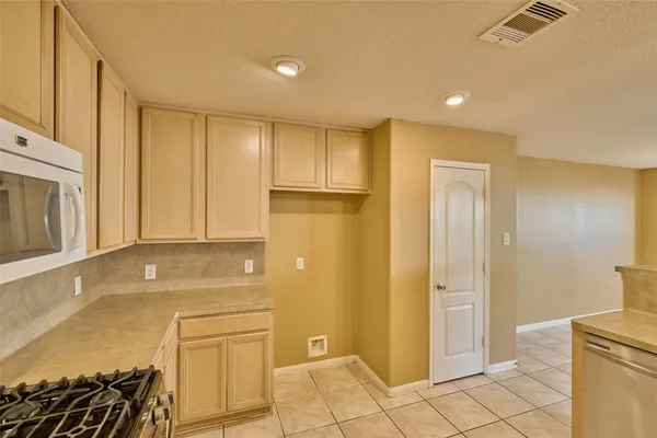 a kitchen with a sink cabinets and window
