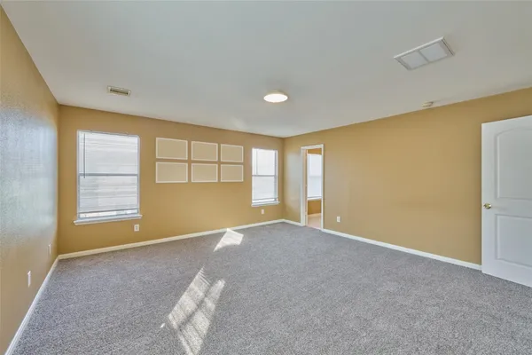 an empty room with a empty space and windows