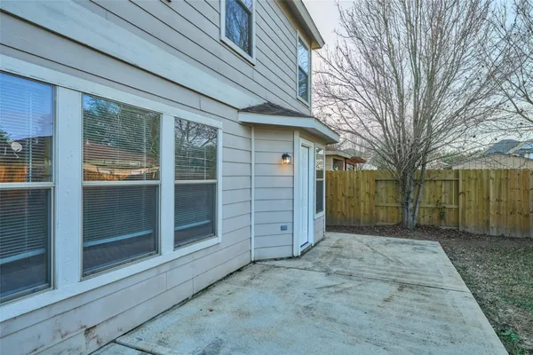 a view of a house with a yard and wooden fence